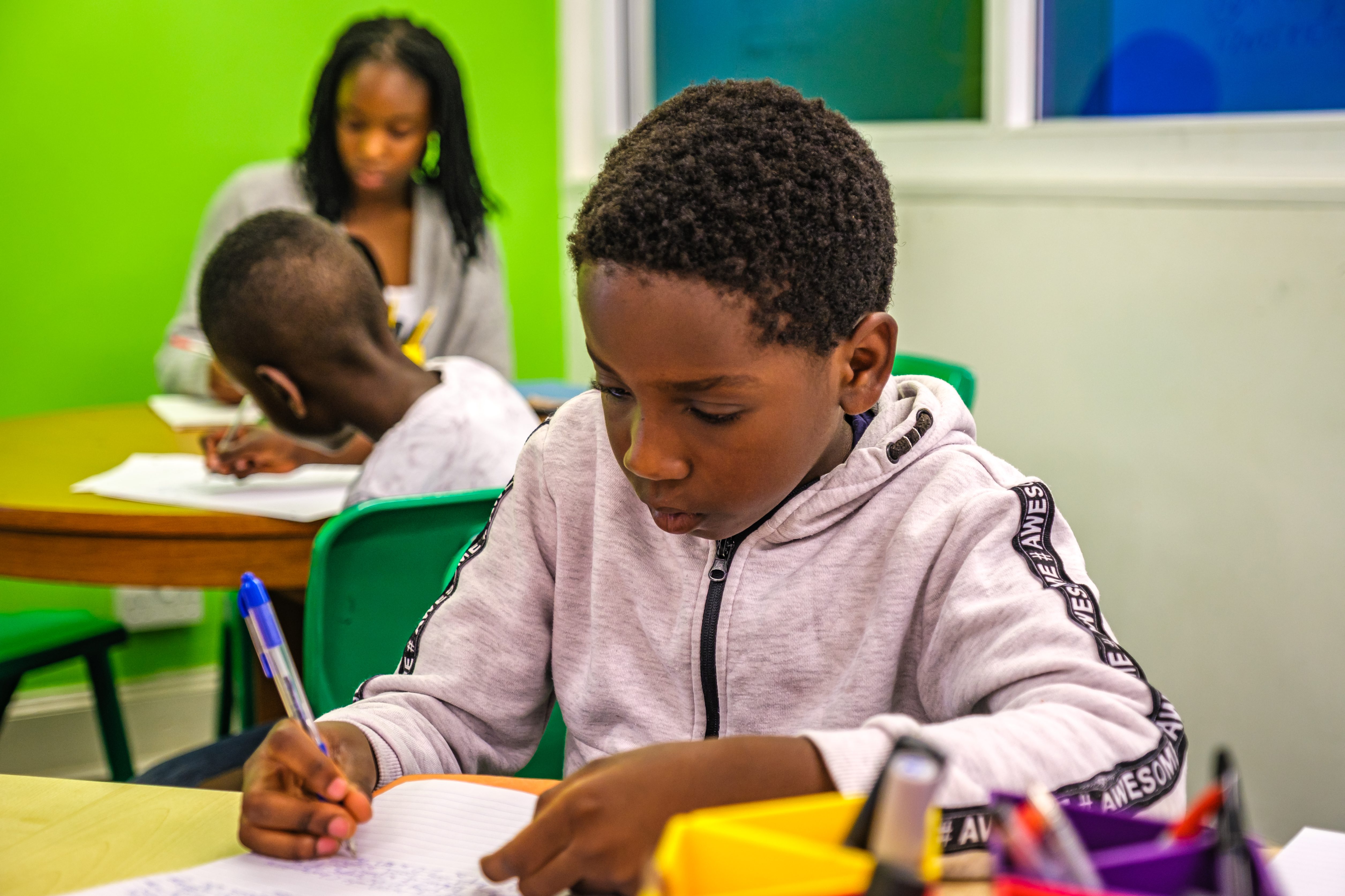 Child completing 11 Plus preparation exercises in a classroom